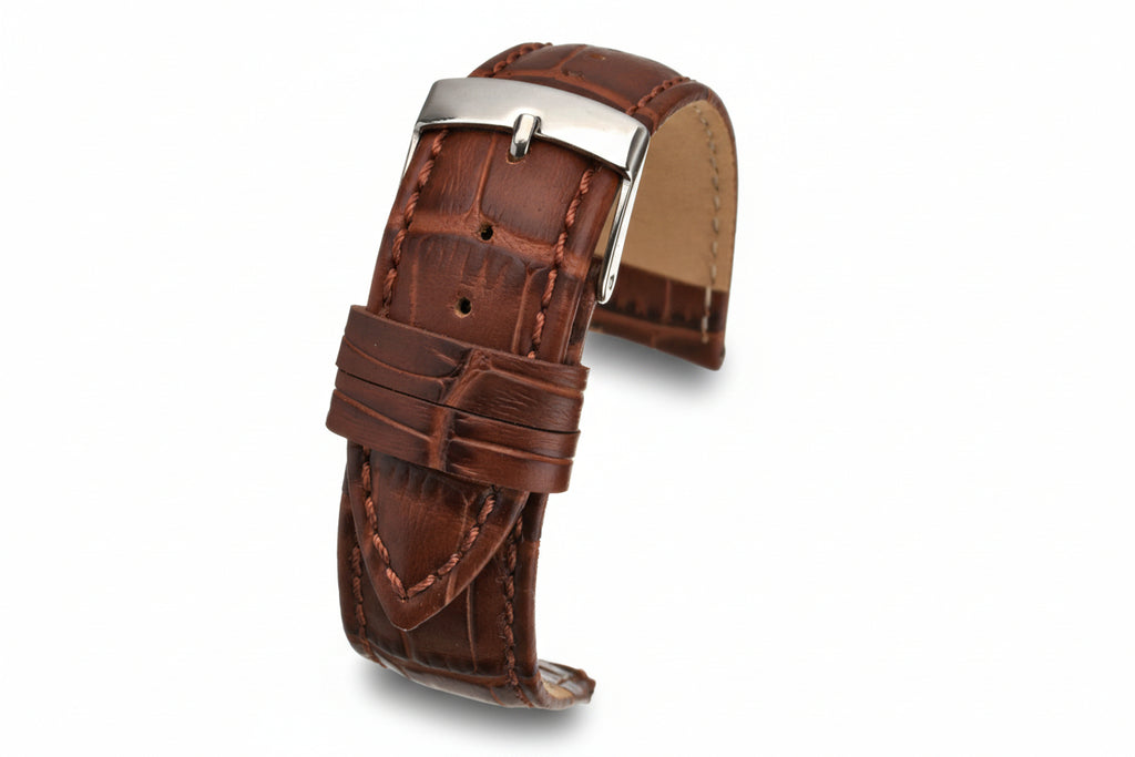 Brown leather watch strap with silver buckle on a white background